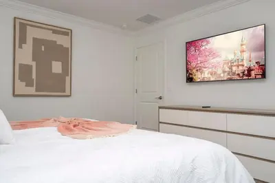 a bedroom with a bed and a tv on the wall at Marvelous 4Bd w Pool Close to Disney at Storey Lake 2629 in Kissimmee