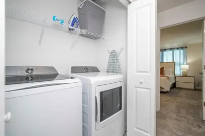 a kitchen with a washer and dryer in a room at Marvelous 4Bd w Pool Close to Disney at Storey Lake 2629 in Kissimmee