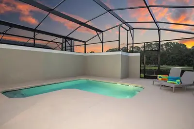 a swimming pool in a house with a glass ceiling at Marvelous 4Bd w Pool Close to Disney at Storey Lake 2629 in Kissimmee
