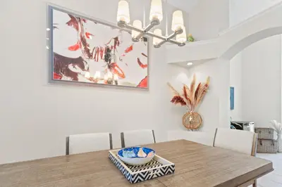 a dining room with a wooden table and chairs at Private Oasis in Kissimmee - Pool, BBQ, Free Parking in Orlando