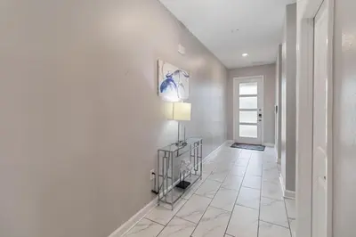 a hallway with a lamp on a white wall at Storey Lake Resort, Private Pool, And Much More!! in Kissimmee