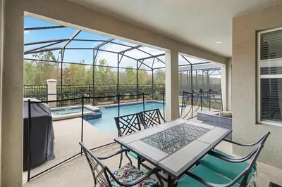 a balcony with a table and chairs and a swimming pool at Storey Lake Resort, Private Pool, And Much More!! in Kissimmee
