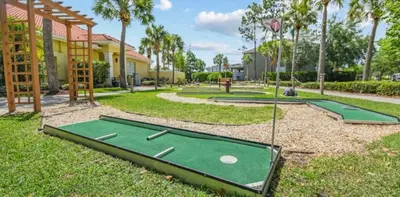a golf course with two putting greens in a park at Restful 4BR 3BA with BBQ, Heated Pool & SPA in Kissimmee