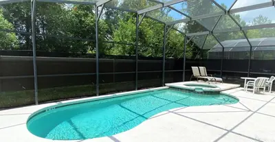 a swimming pool in a building with a glass house at Comfort Home with BBQ, Private Pool & Hot tub in Kissimmee