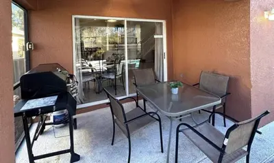 a dining room with a table and chairs and a window at Comfort Home with BBQ, Private Pool & Hot tub in Kissimmee