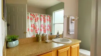 a bathroom with a sink and a mirror at Comfort Home with BBQ, Private Pool & Hot tub in Kissimmee
