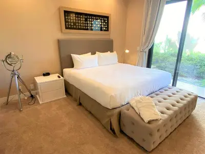 a bedroom with a large white bed with a large window at Family Home w BBQ, 7 Min from Disney, Accessible in Orlando