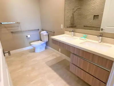 a bathroom with two sinks and a toilet at Family Home w BBQ, 7 Min from Disney, Accessible in Orlando