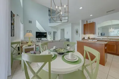 a kitchen and dining room with a table and chairs at 558 - Veranda Palms House in Kissimmee