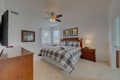 a bedroom with a bed and a ceiling fan at 558 - Veranda Palms House in Kissimmee