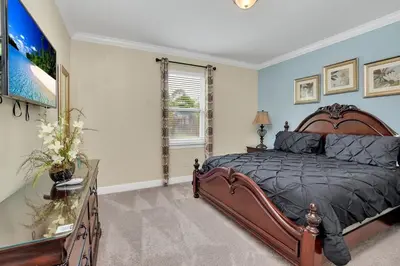 a bedroom with a large bed and a window at 450 Paradise 8BD Villa- Game Room PoolSpa in Orlando