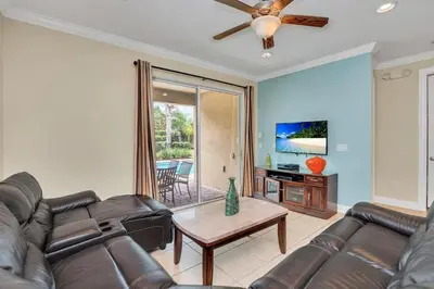 a living room with a couch and a table at 450 Paradise 8BD Villa- Game Room PoolSpa in Orlando