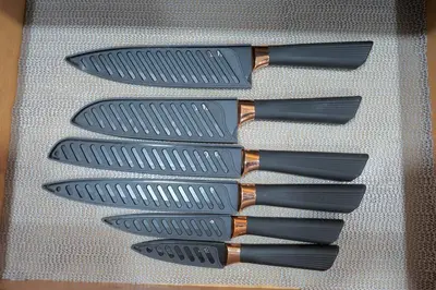 a group of four knives sitting on a table at Peaceful Home in Central Florida Near Universal in Orlando