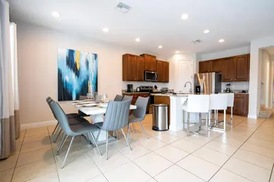 a kitchen and dining room with a table and chairs at Unforgettable Experience Luxury Vacation Home 7479 in Orlando