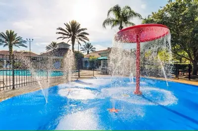 a fountain in the middle of a pool at Family Friendly Disney Villa (4 Miles from Disney) in Kissimmee