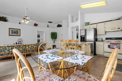 a dining room and kitchen with a glass table and chairs at 2974 Viscount Villa 3bed+ Pool&Spa in Kissimmee