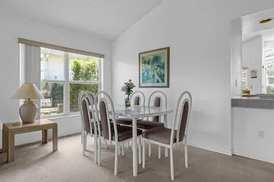 a dining room with a glass table and chairs at 2974 Viscount Villa 3bed+ Pool&Spa in Kissimmee
