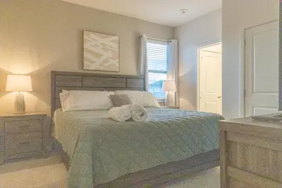 a bedroom with a bed with a towel on it at Summer Fun - Waterfront 8BR Home with Private Pool! in Kissimmee