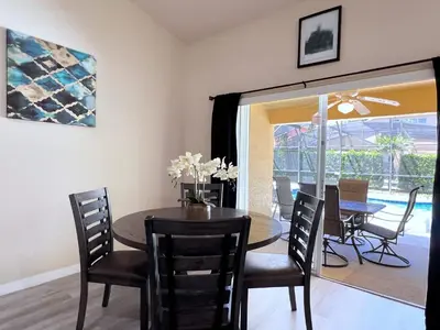 a dining room with a wooden table and chairs at Lovely 3-Bedroom Pool Villa-1445SCD in Orlando