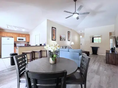 a living room and kitchen with a table and a couch at Lovely 3-Bedroom Pool Villa-1445SCD in Orlando