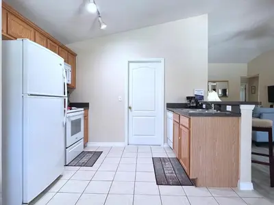 a kitchen with white appliances and a white refrigerator at Lovely 3-Bedroom Pool Villa-1445SCD in Orlando