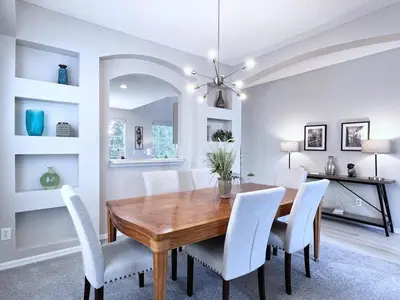 a dining room with a wooden table and white chairs at Spacious 7Bd Pool Gm Hm Terra Verde Resort-211HBL in Kissimmee