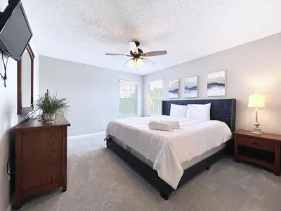 a bedroom with a bed and a ceiling fan at Spacious 7Bd Pool Gm Hm Terra Verde Resort-211HBL in Kissimmee