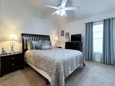 a bedroom with a bed and a ceiling fan at Cozy 4 Bed 3 Bath Pool Hm with Game Room-4450NP in Kissimmee