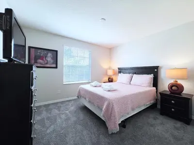 a bedroom with a large bed and a window at Beautiful 6Bd Pool Hm Veranda Palms-4464NP in Kissimmee