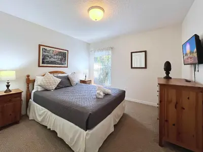 a bedroom with a bed and a television in it at Lovely Lakeside 4-Bed Pool Home at Villa Sol-3125 in Kissimmee