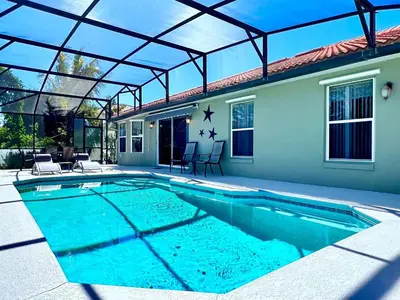 a swimming pool with a glass roof and a house at Lovely Lakeside 4-Bed Pool Home at Villa Sol-3125 in Kissimmee