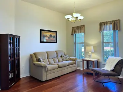 a living room with a couch and a chair at Lovely Lakeside 4-Bed Pool Home at Villa Sol-3125 in Kissimmee