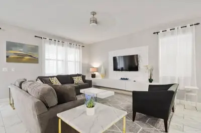 a living room with a couch and a table at 33 Disney Villa GameRoom Movie Theater Pool in Kissimmee