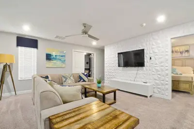 a living room with a couch and a tv at 33 Disney Villa GameRoom Movie Theater Pool in Kissimmee