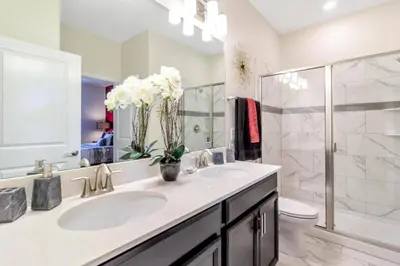 a bathroom with a sink and a toilet and a shower at 33 Disney Villa GameRoom Movie Theater Pool in Kissimmee