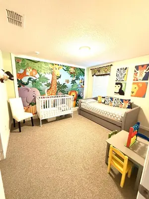a childs room with a crib and a table at 33 Disney Villa GameRoom Movie Theater Pool in Kissimmee