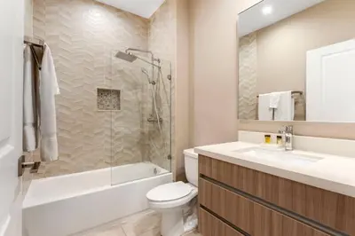 a bathroom with a toilet and a sink and a shower at 7594 Magic Village 3suites 6guets 8 min Disney in Orlando