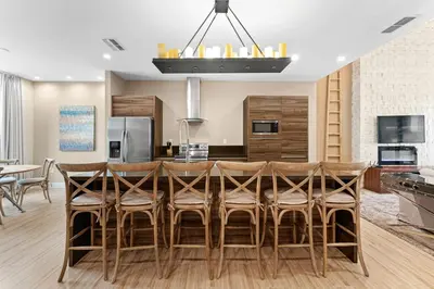 a kitchen and dining room with a table and chairs at 7545 Magic Village 4 suites 8 guests 8 min Disney in Orlando