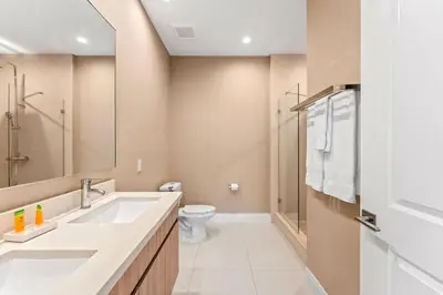 a bathroom with a sink and a toilet at 7545 Magic Village 4 suites 8 guests 8 min Disney in Orlando