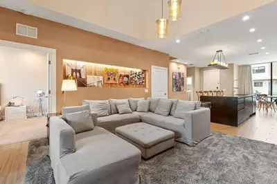 a living room with a couch and a dining room at 3081 Magic Village 4suites Jacuzzi Near 192 8 min Disney in Orlando