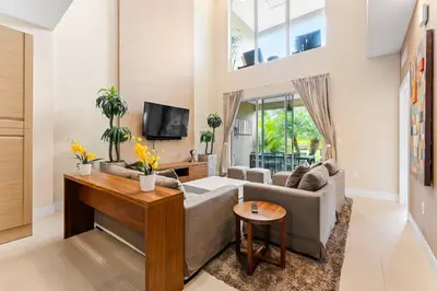 a living room with a couch and a tv at 7659 Magic Village Excellent 4 suites 6 min Disney in Orlando