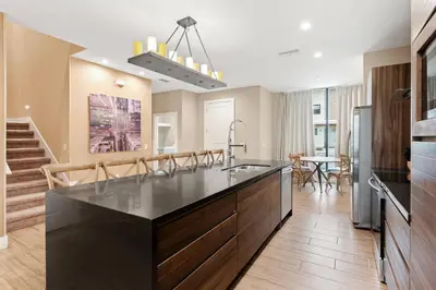 a kitchen with a large black counter top in a room at 7490 Magic Village 4suites 8 guests 8 min Disney in Orlando