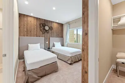 a bedroom with two beds and a window at 7490 Magic Village 4suites 8 guests 8 min Disney in Orlando