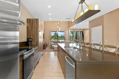 a kitchen with stainless steel appliances and a large island at 7564 Magic Village 3 suites jacuzzi BBQ 8 min Disney in Orlando