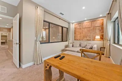 a living room with a table and a couch at 7564 Magic Village 3 suites jacuzzi BBQ 8 min Disney in Orlando