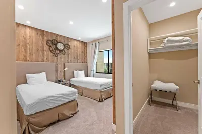 a hotel room with two beds and a window at 7564 Magic Village 3 suites jacuzzi BBQ 8 min Disney in Orlando