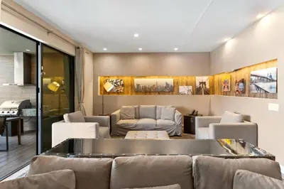 a living room with a couch and chairs at 7564 Magic Village 3 suites jacuzzi BBQ 8 min Disney in Orlando