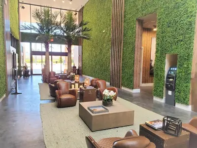 a lobby with couches and chairs and plants at 3045 Magic Village8 guests 4 suites BBQ 8 min Disney in Orlando