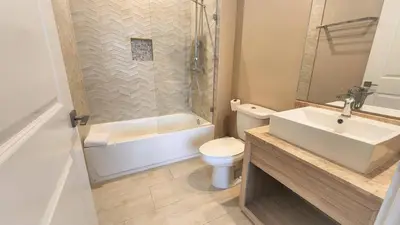 a bathroom with a sink and a toilet and a shower at 3053 Magic Village 3 suites jacuzzi BBQ 6min Disney in Orlando