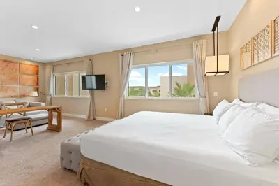 a bedroom with a large white bed and a table at 7562 Magic Village nice 8guests 4suites 8 min Disney in Orlando